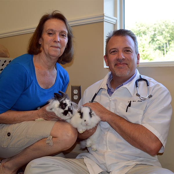 Greg Nutt DVM with client and her rabbits